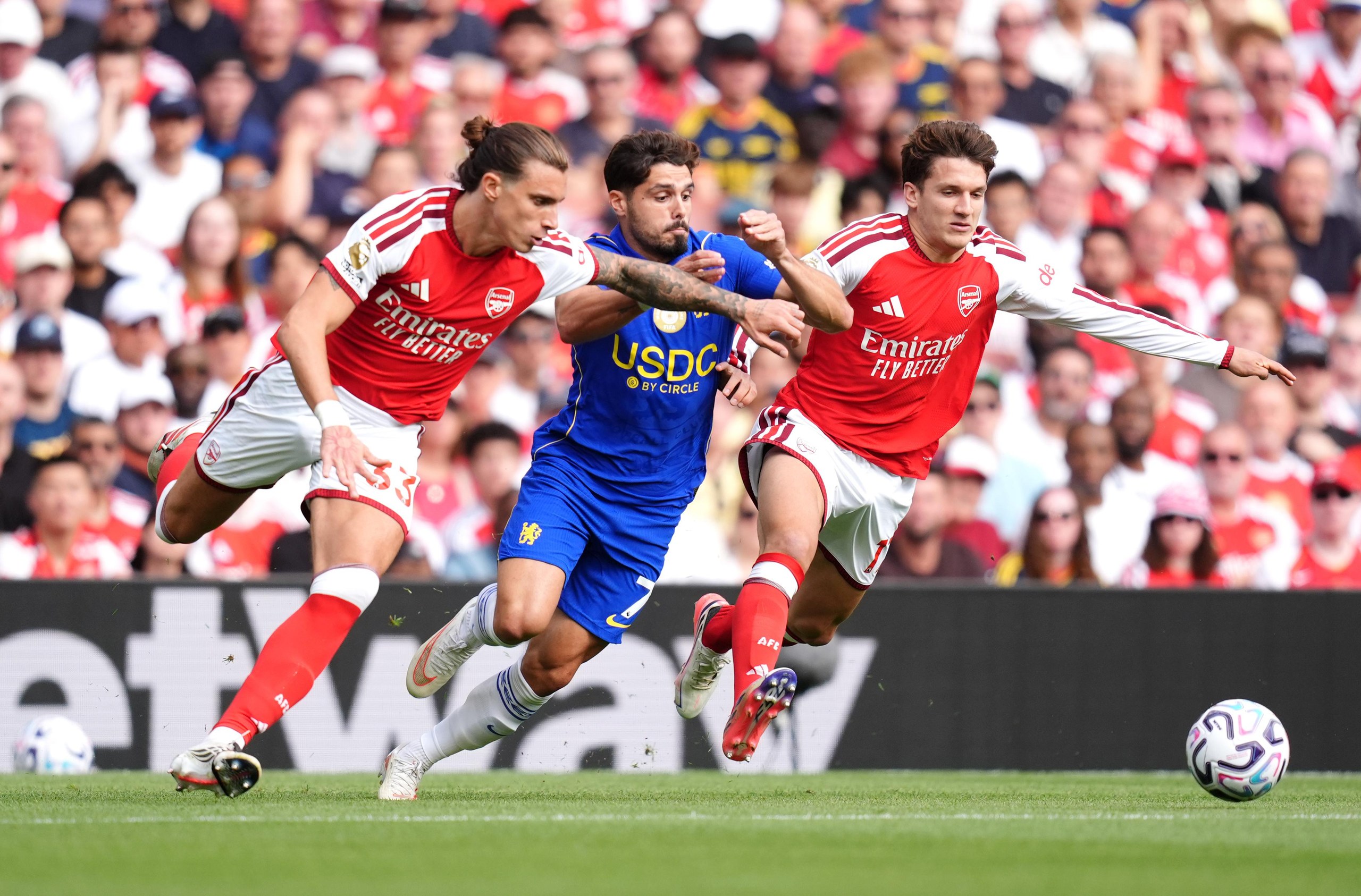 Arsenal’s Riccardo Calafiori and Christos Tzolis sandwich Chelsea’s Pedro Neto