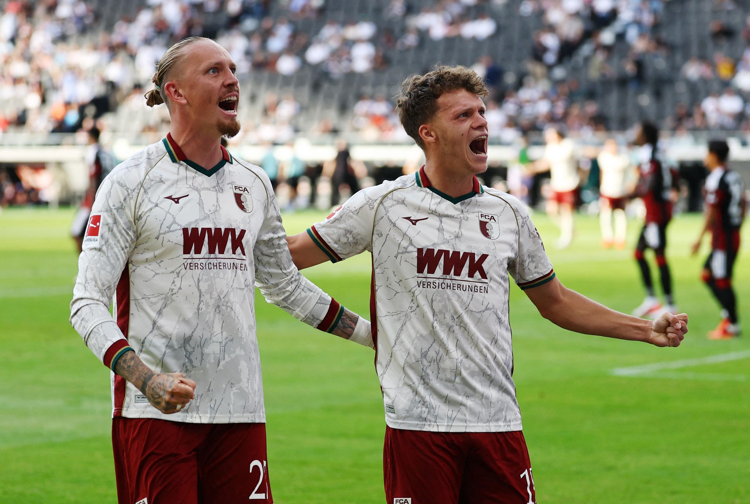 Augsburg’s Robin Fellhauer (right) celebrates his goal against Eintracht Frankfurt with team-mate Marius Wolf.