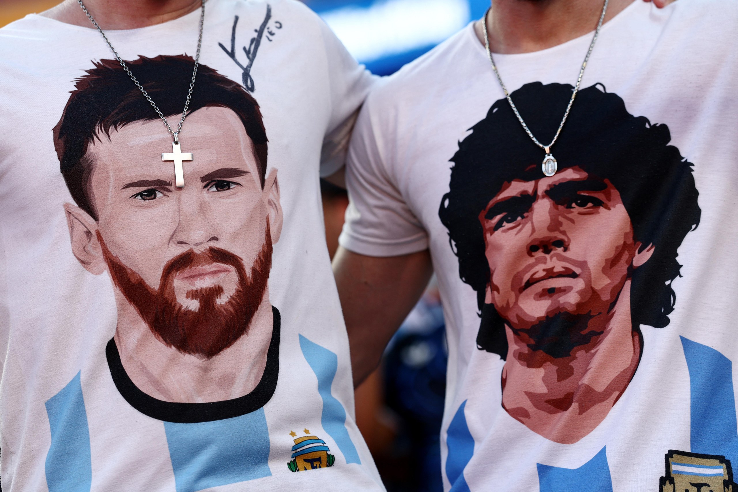 Argentina fans wearing T-shirts depicting Lionel Messi and Diego Maradona